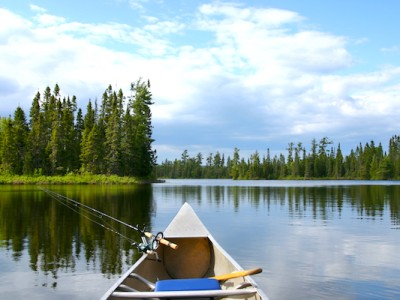 Aluminum canoe with fishing gear heading out on a northern Minnesota lake